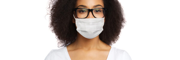 health, pandemic and safety concept - african american young woman wearing face protective medical mask for protection from virus disease over white